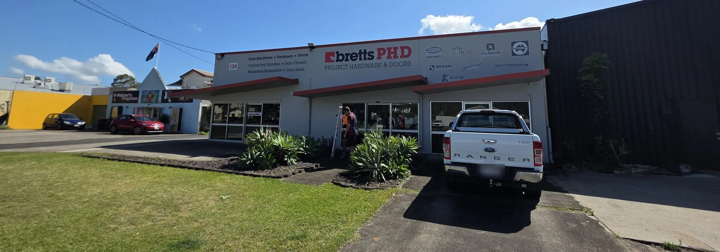 The Bretts PHD Project Hardware & Doors shopfront at 124 Buchan St, Cairns, with its services and supplier brands on the façade.